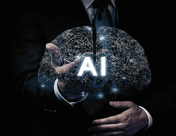 A brain-like network with the the letters AI in front of it which is held by a business man in suit